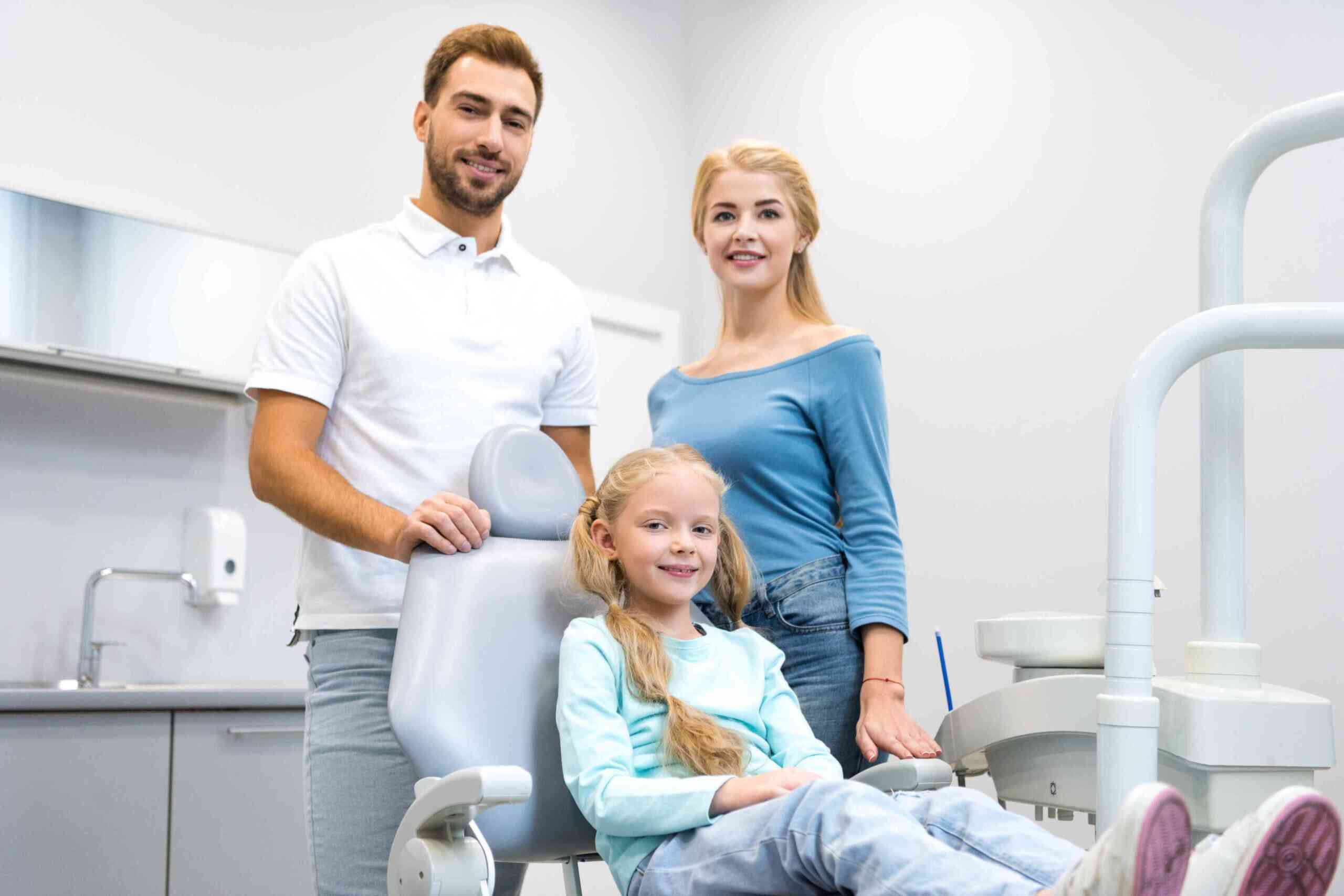 Family with child at dental visit.