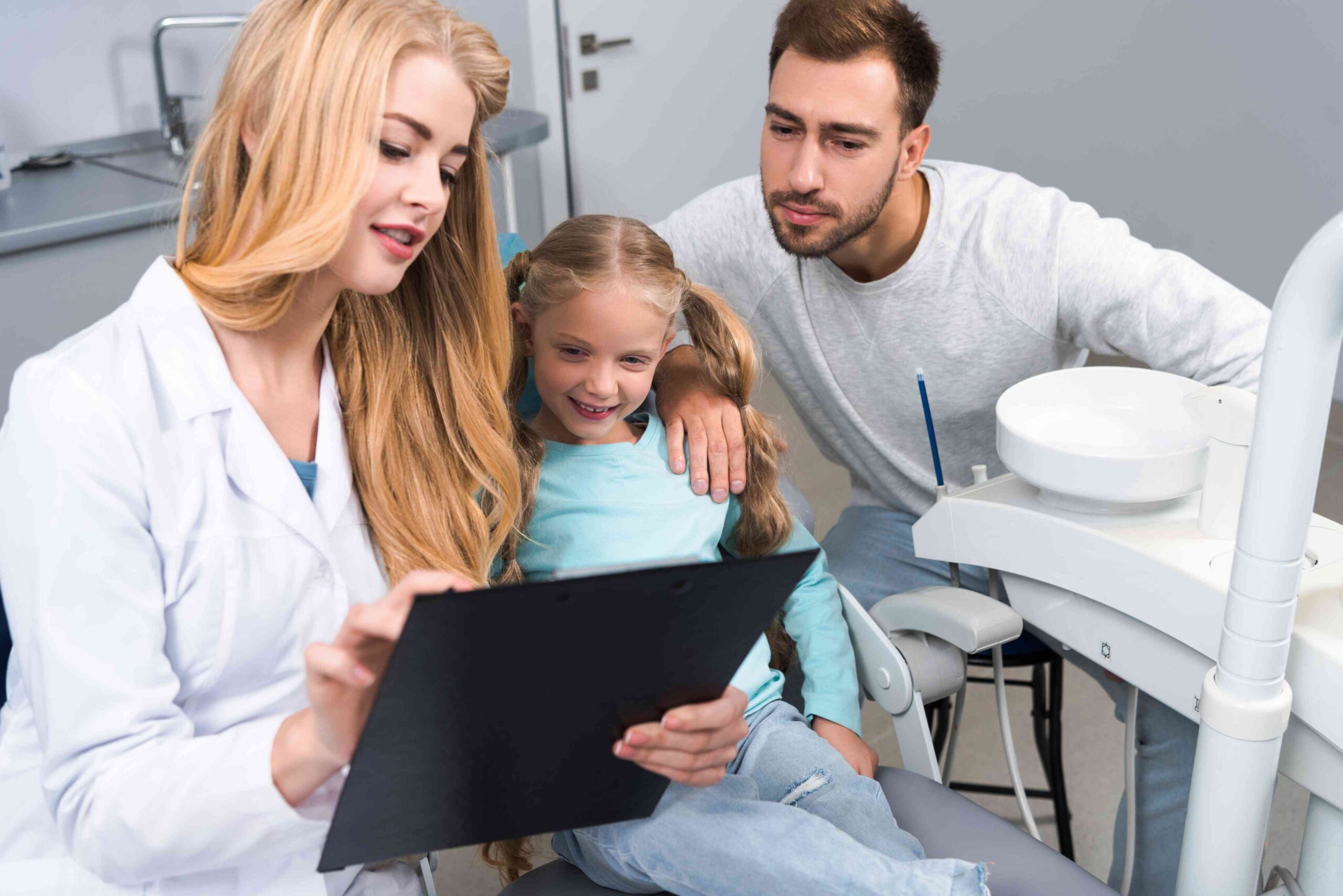 Dentist reviewing treatment plan with family.